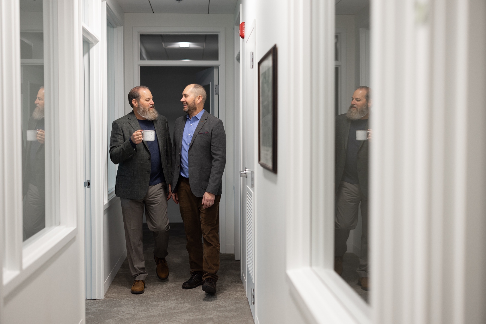 Professional hallway with glass office doors at Soaring Suites