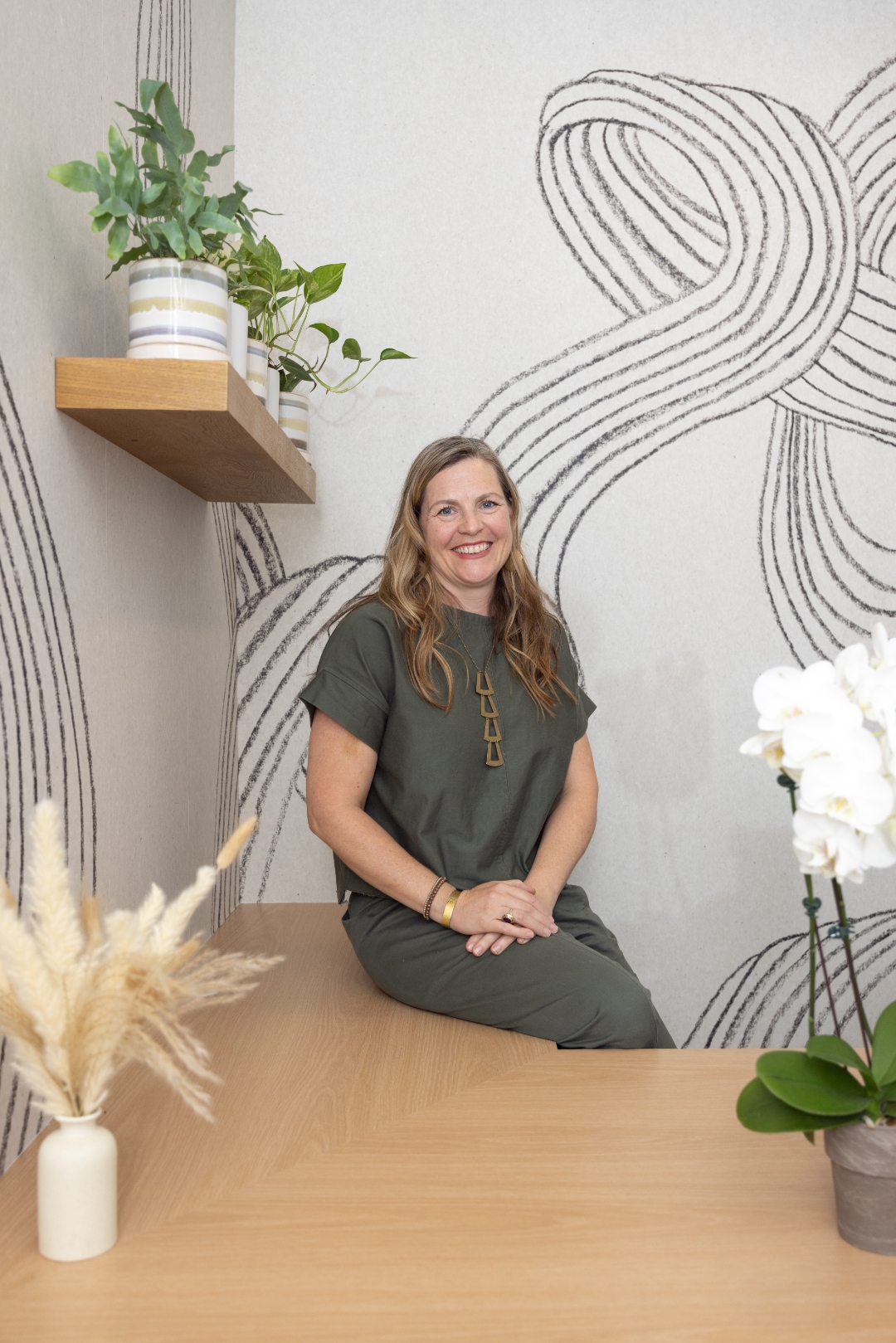 Team member at her desk with abstract art